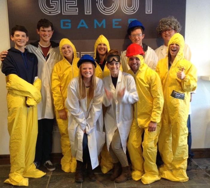 a group of friends pose in costumer after completing an escape room at Freshfield